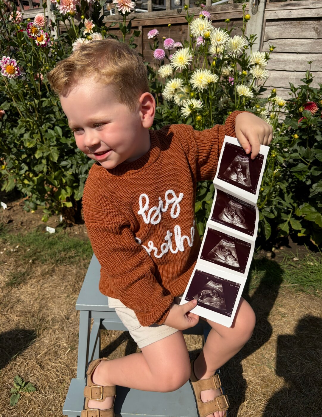 Ira showing the baby scan photographs