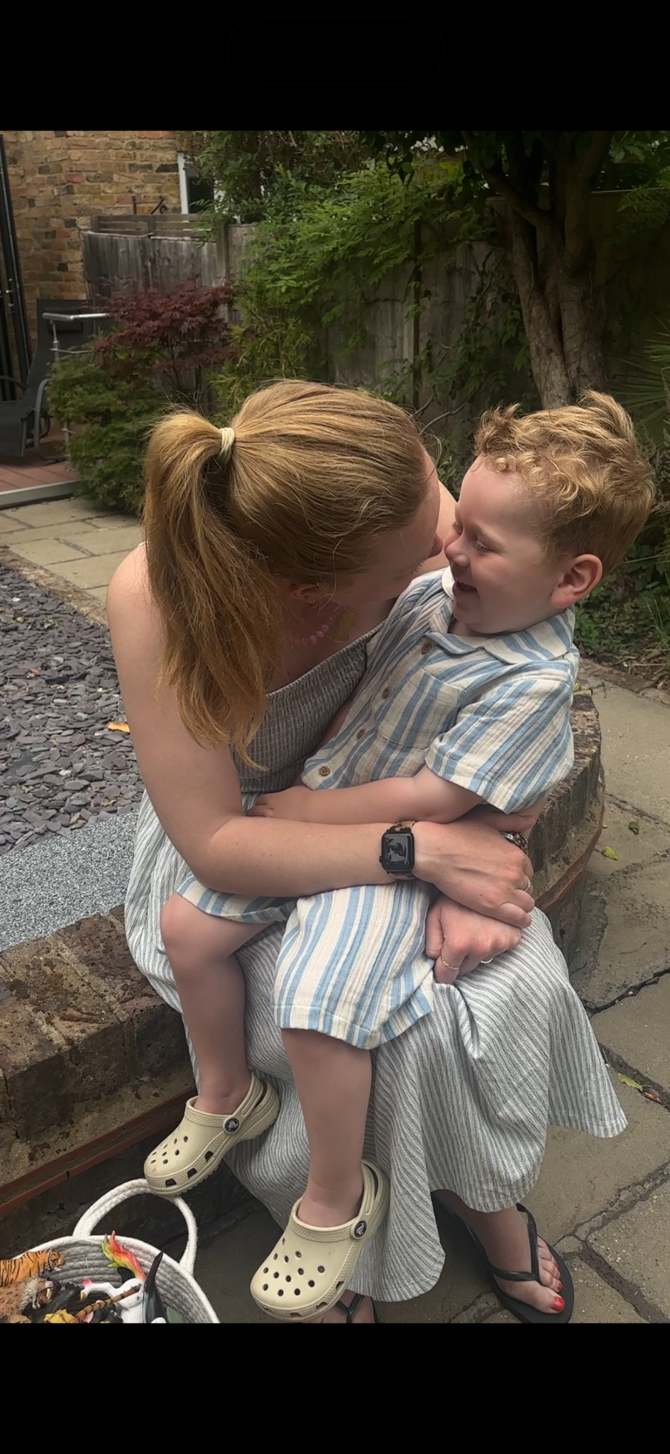 Alice cuddling Ira in the garden