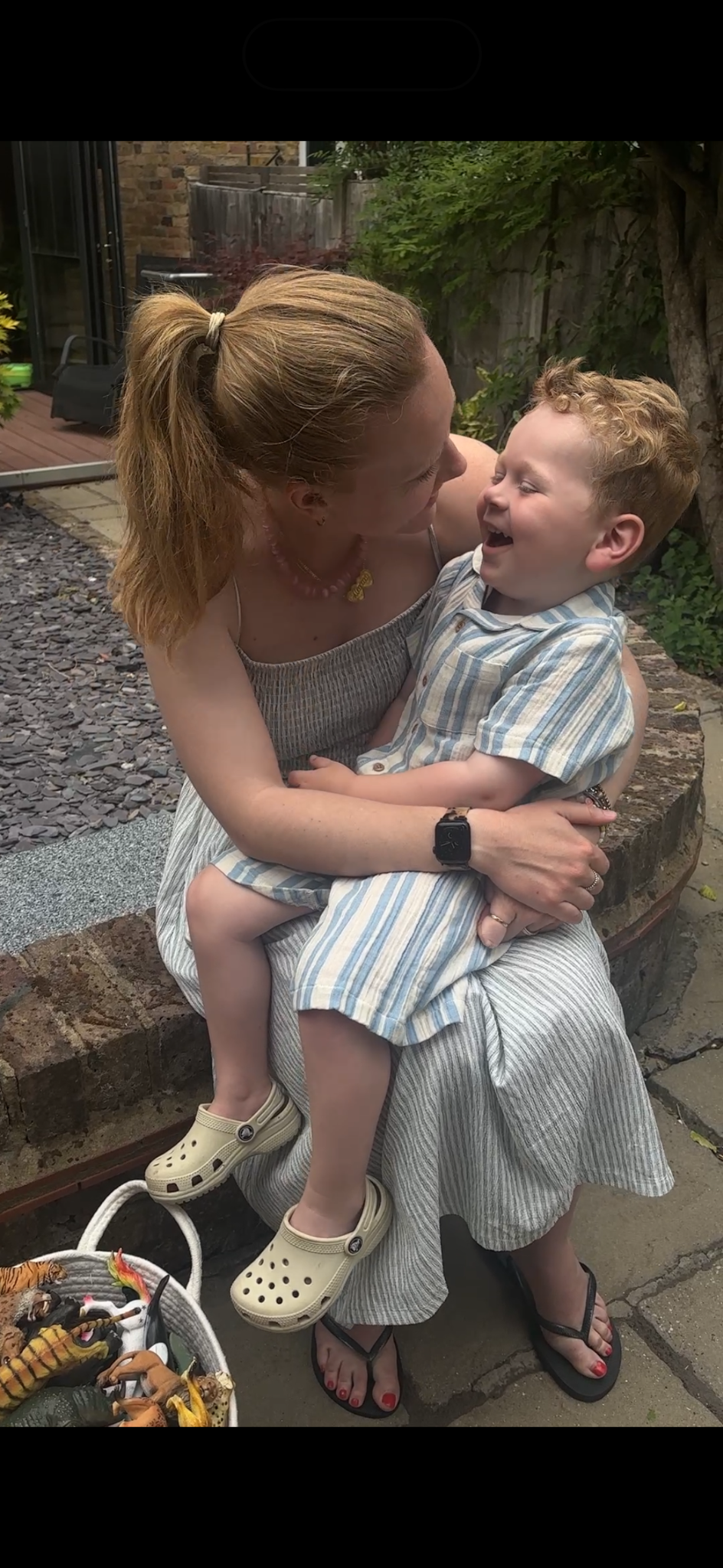 Alice and Ira laughing together in the garden