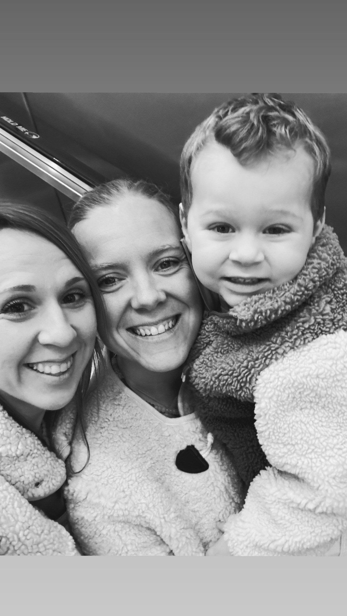 Alice, Amy and Ira in a black and white family selfie