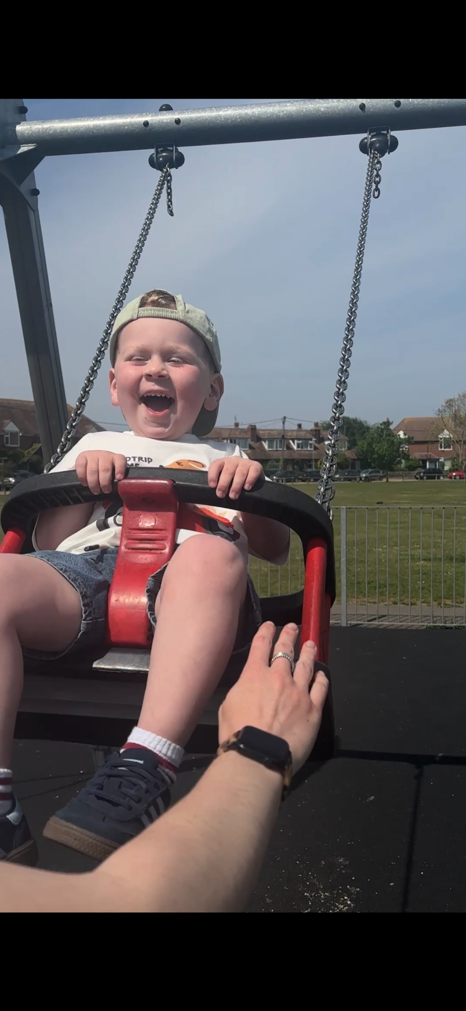 Ira laughing on a swing